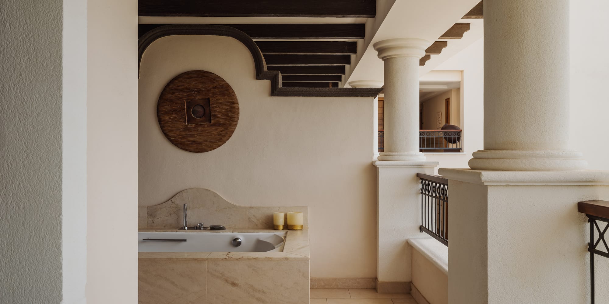a bathroom with a tub and a railing