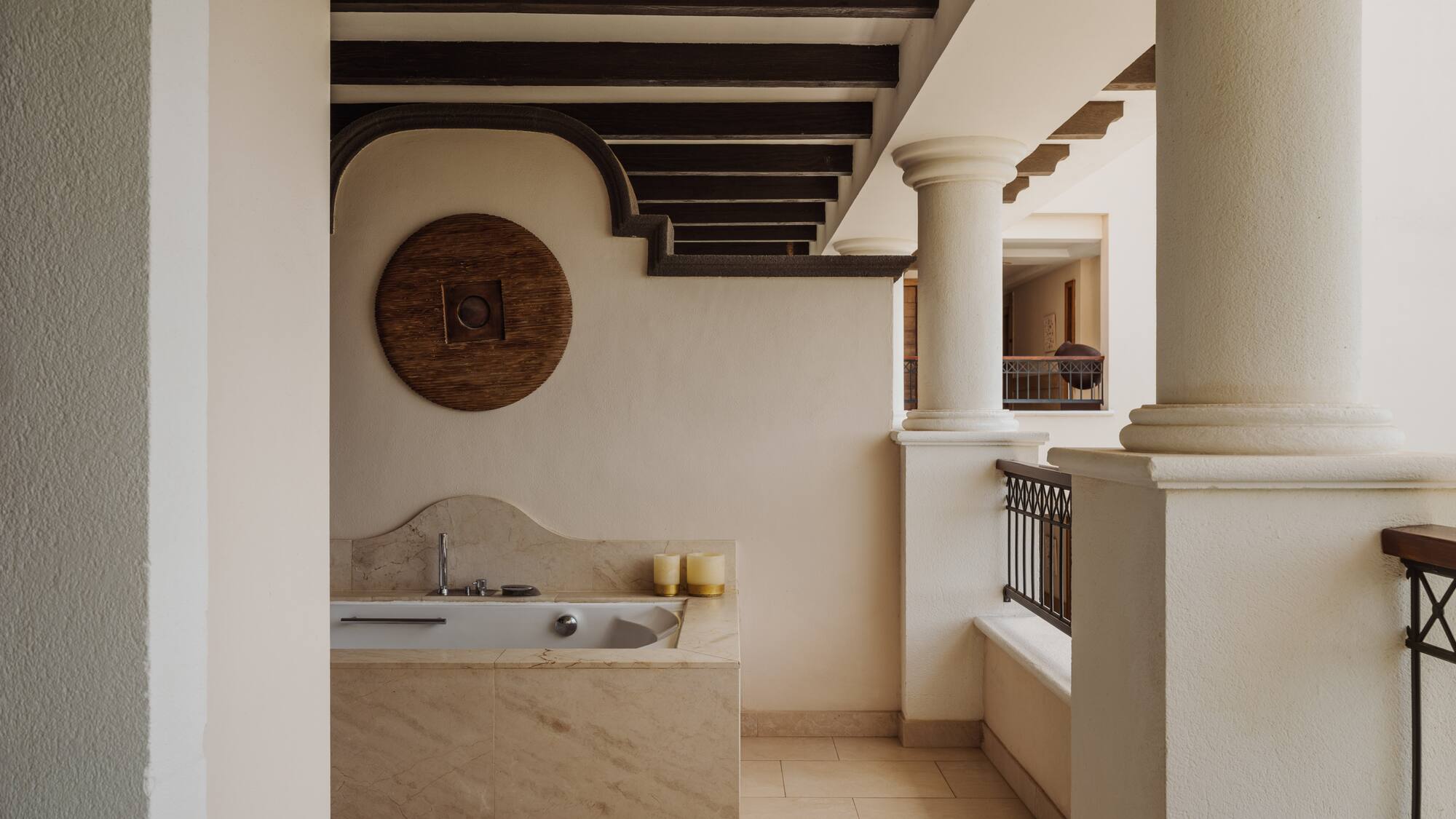 a bathroom with a tub and a railing