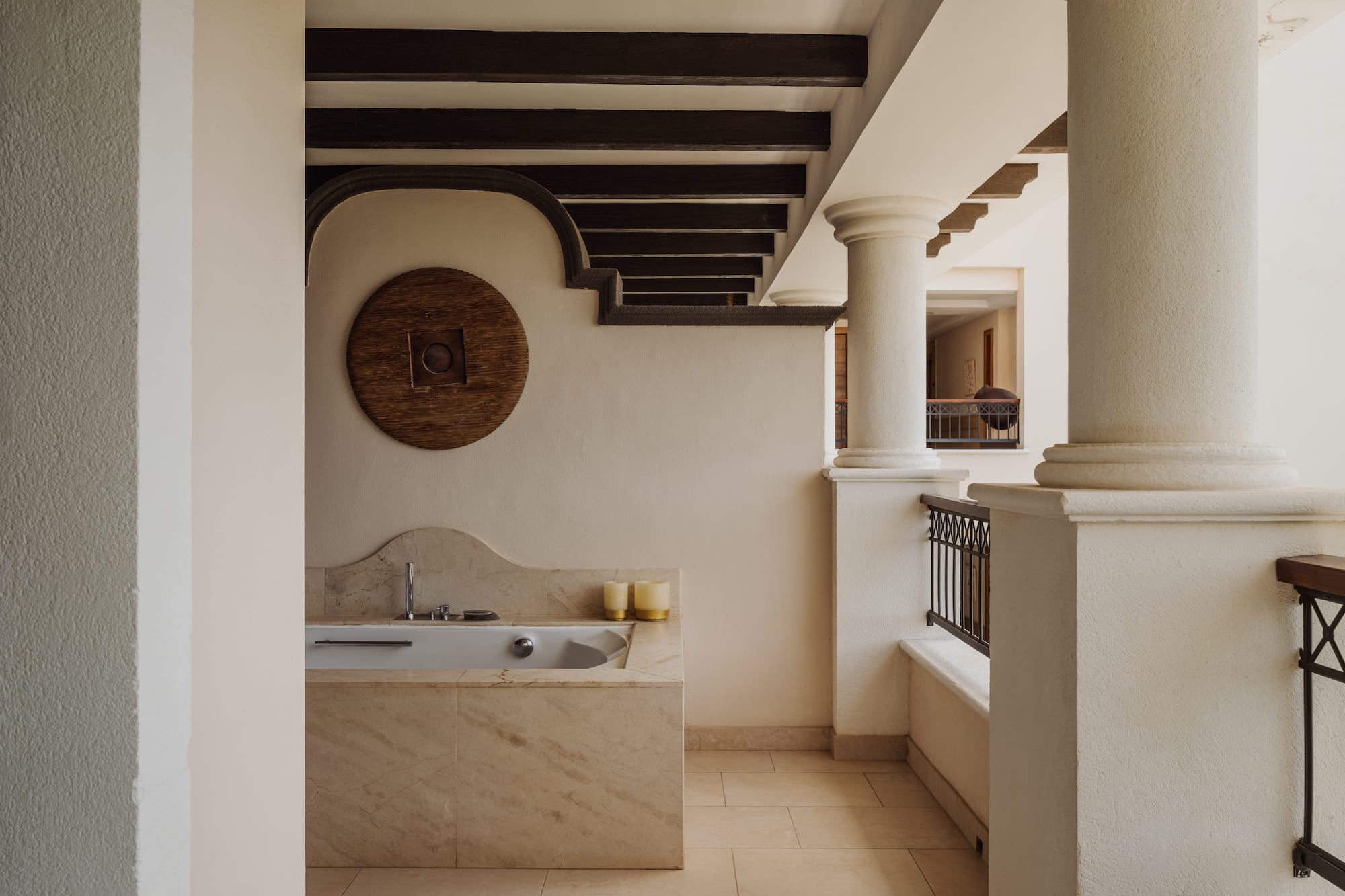 a bathroom with a tub and a railing