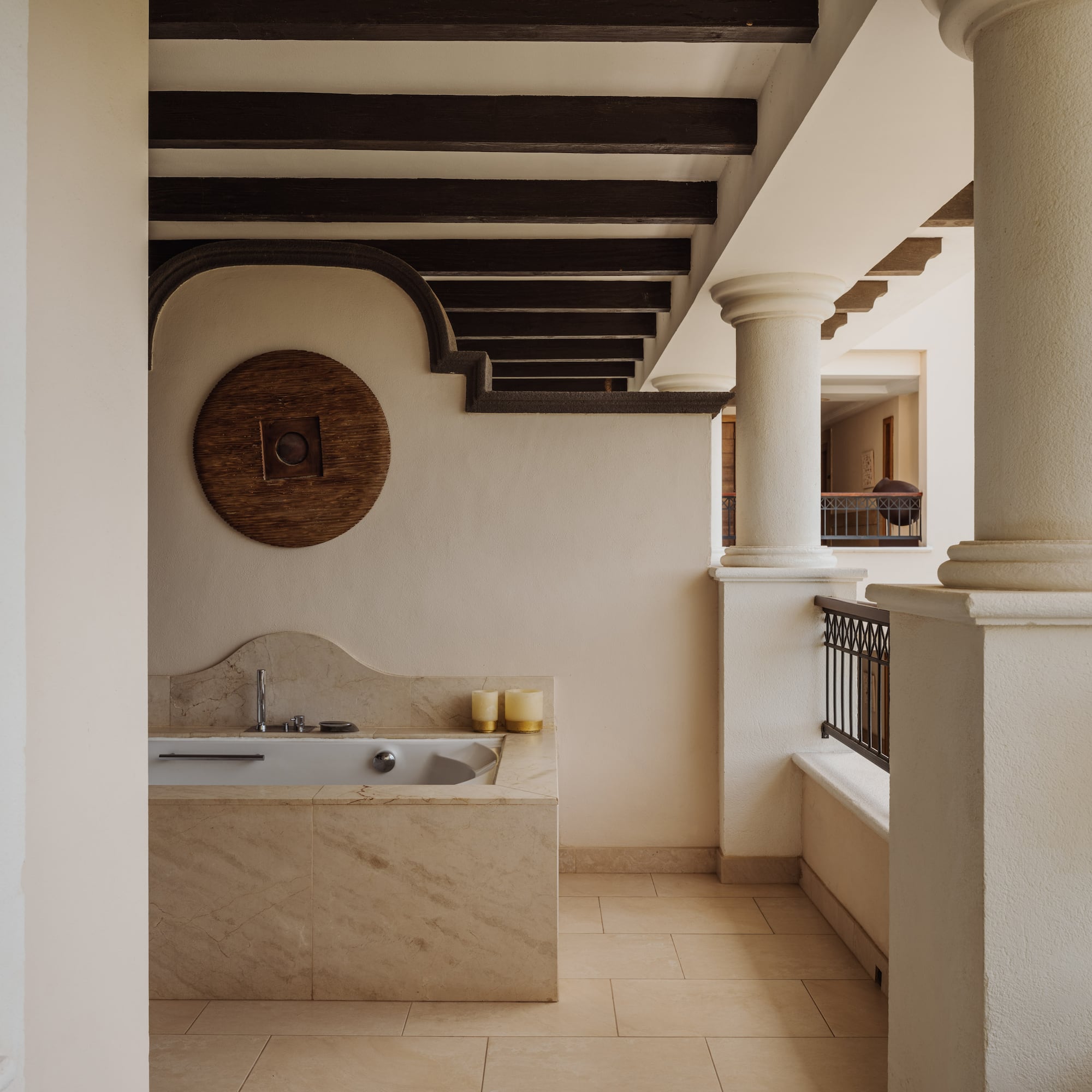 a bathroom with a tub and a railing