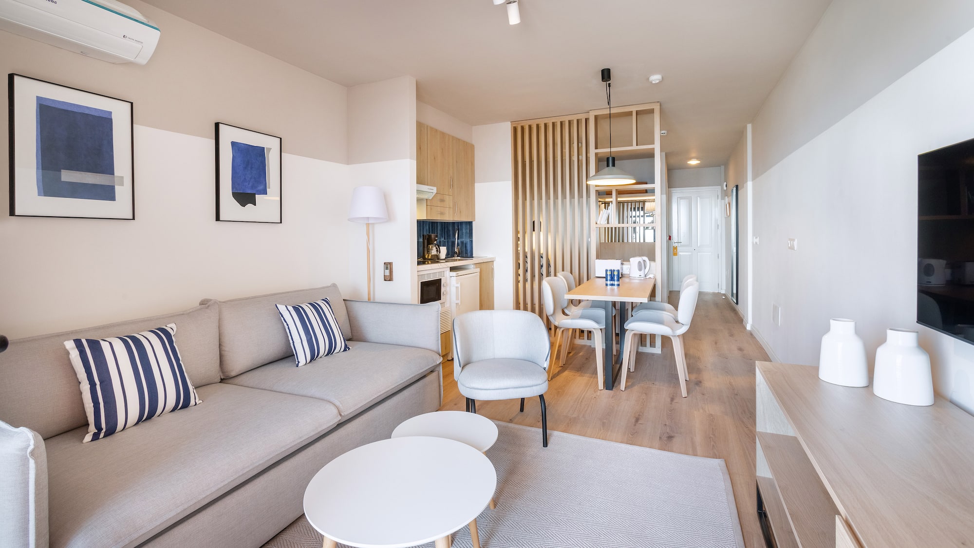 a living room with a couch and dining table