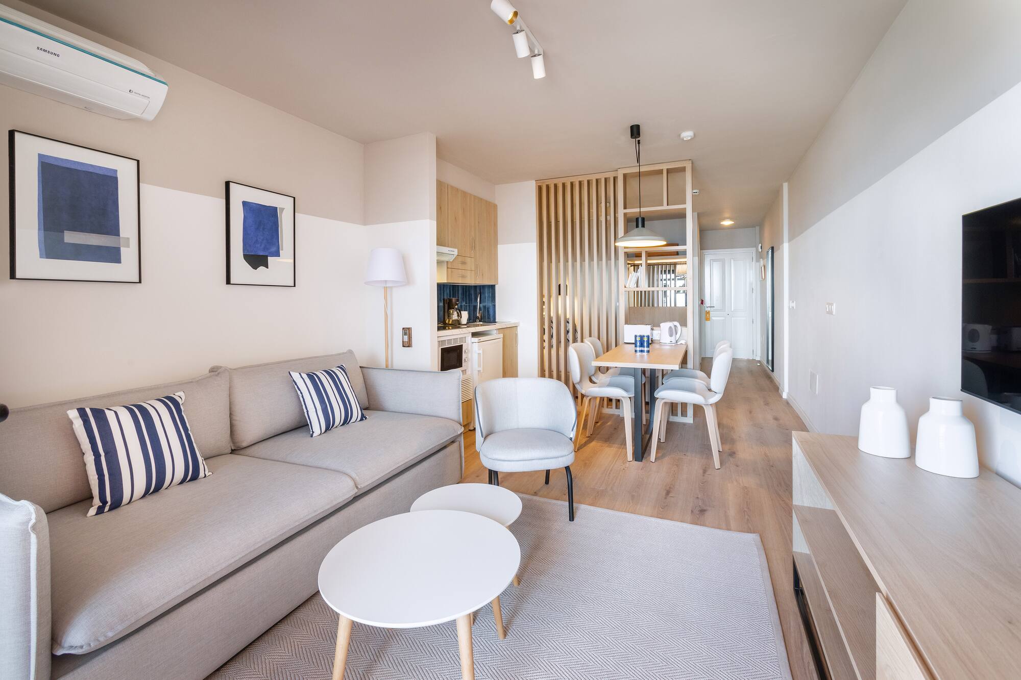 a living room with a couch and dining table