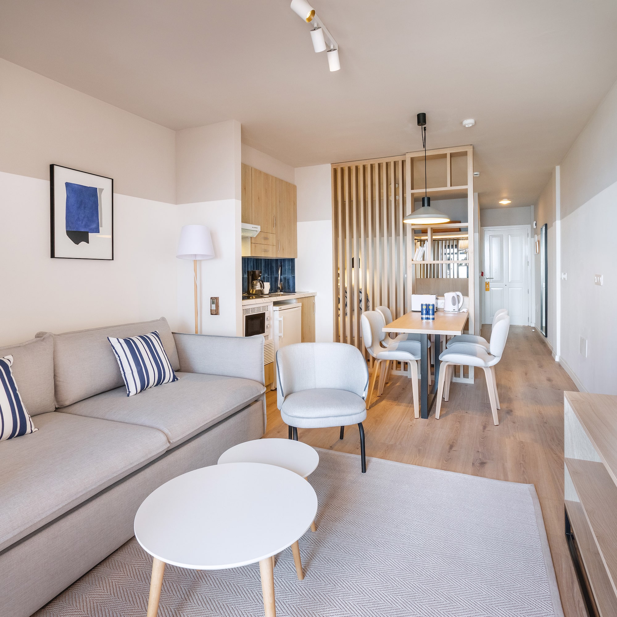 a living room with a couch and dining table