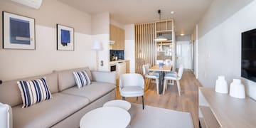 a living room with a couch and dining table