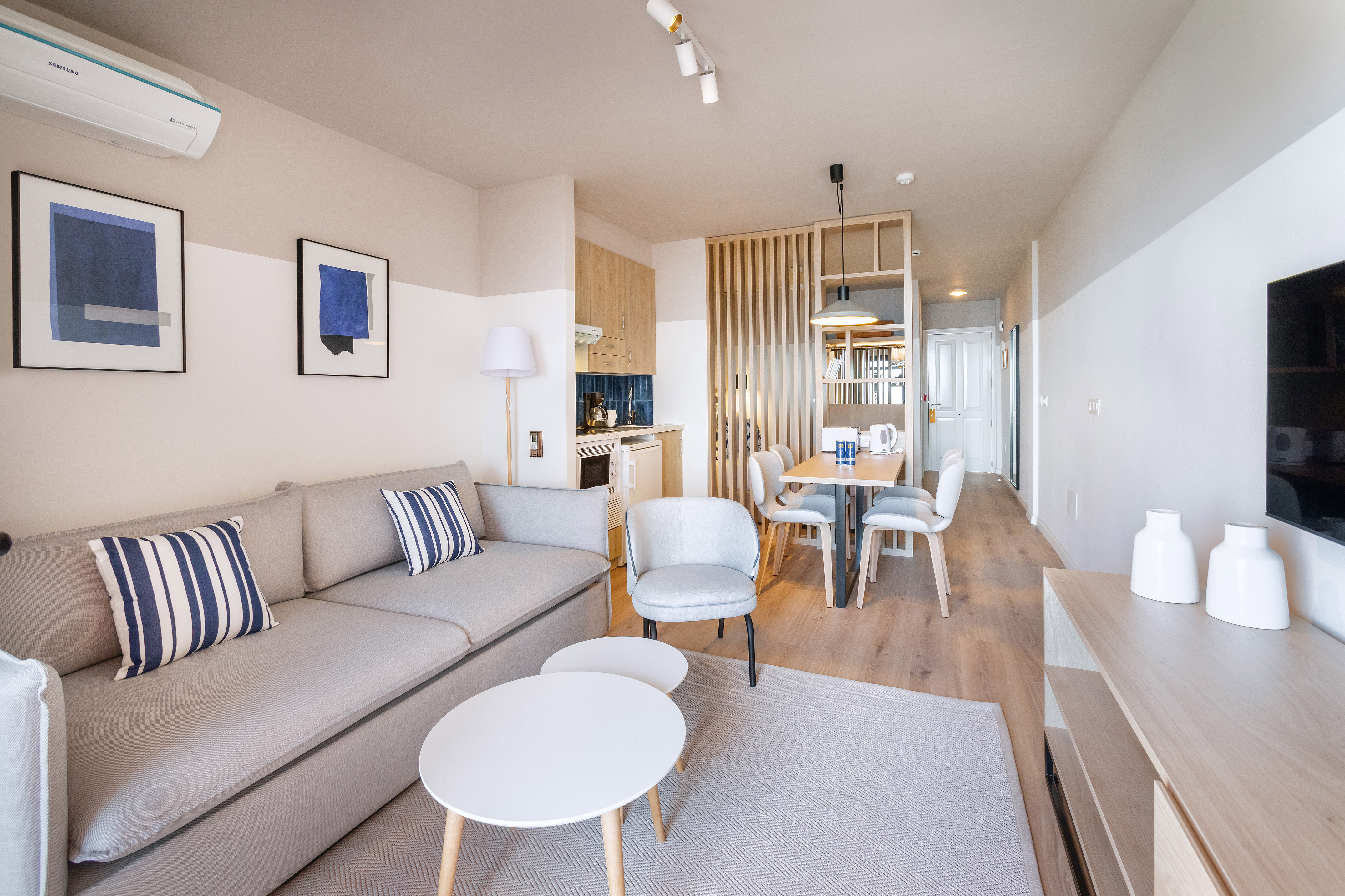 a living room with a couch and dining table