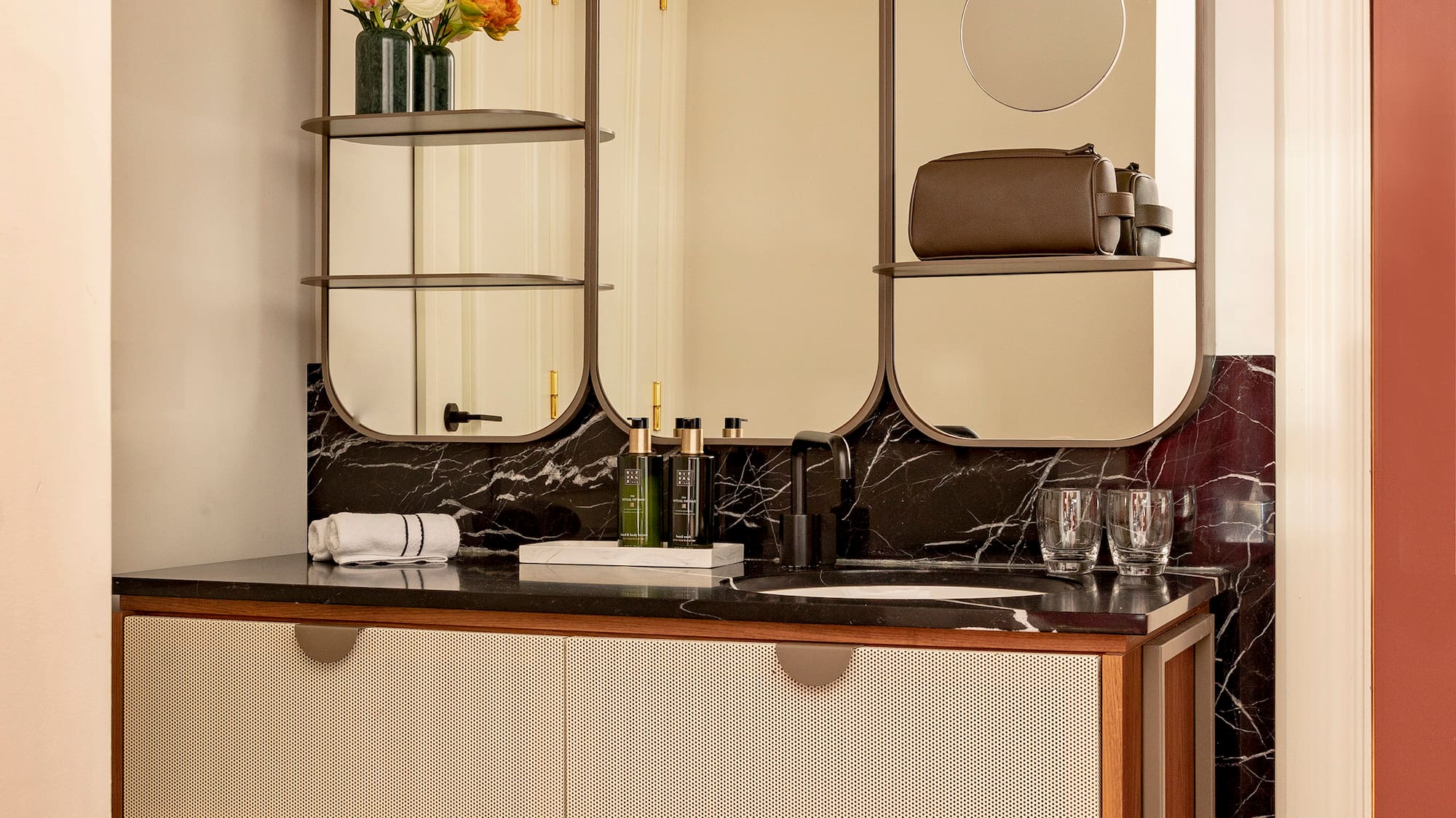 a bathroom with a mirror and a sink