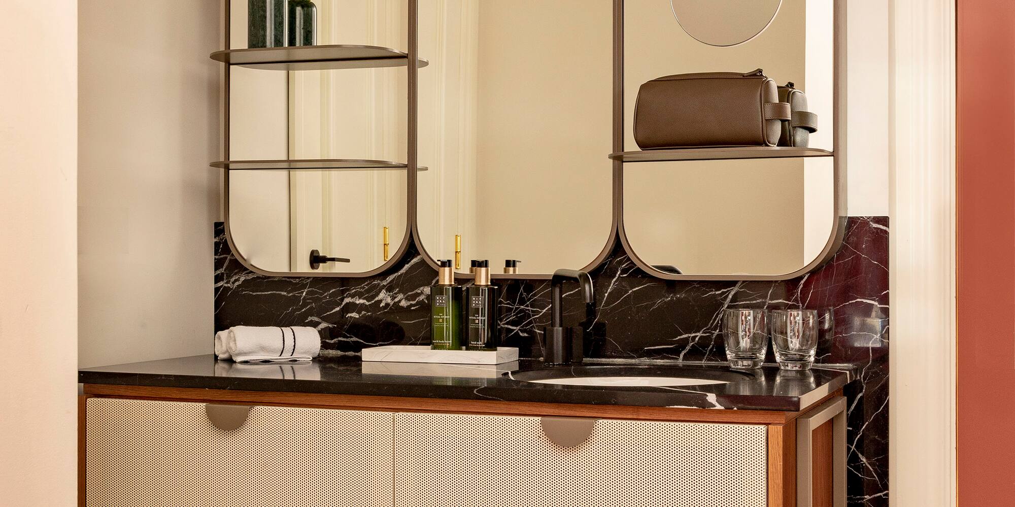 a bathroom with a mirror and a sink