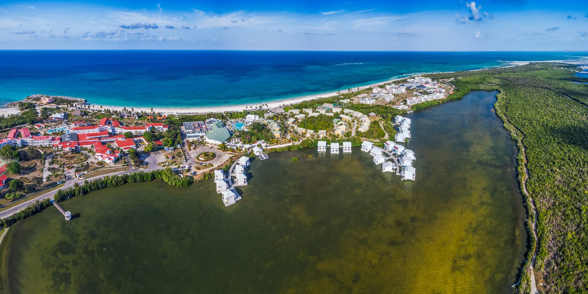 a body of water with buildings and a beach