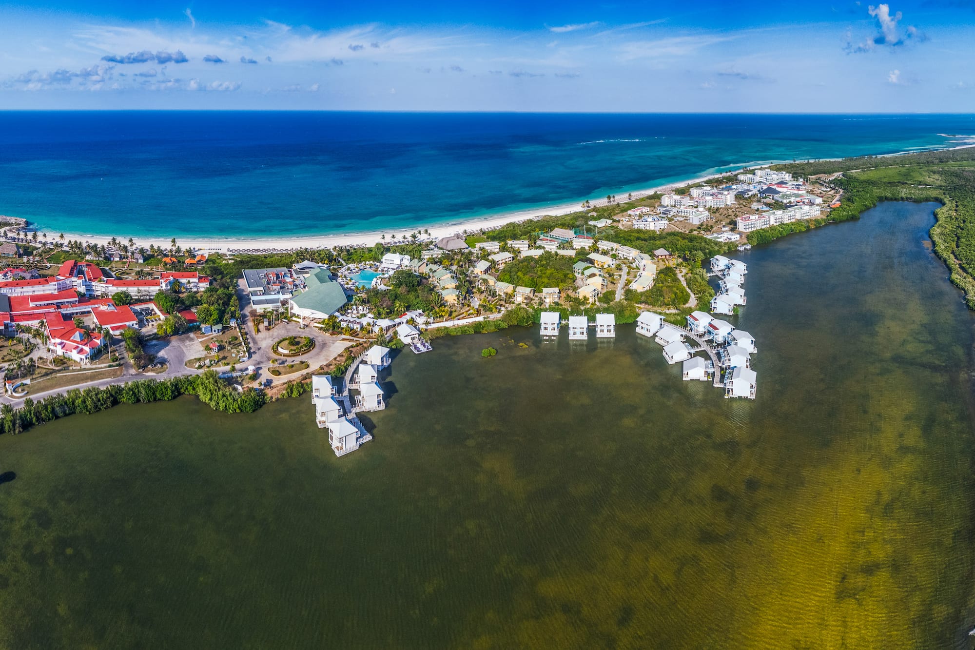 a body of water with buildings and a beach