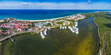a body of water with buildings and a beach