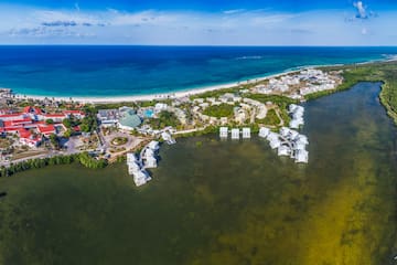 a body of water with buildings and a beach