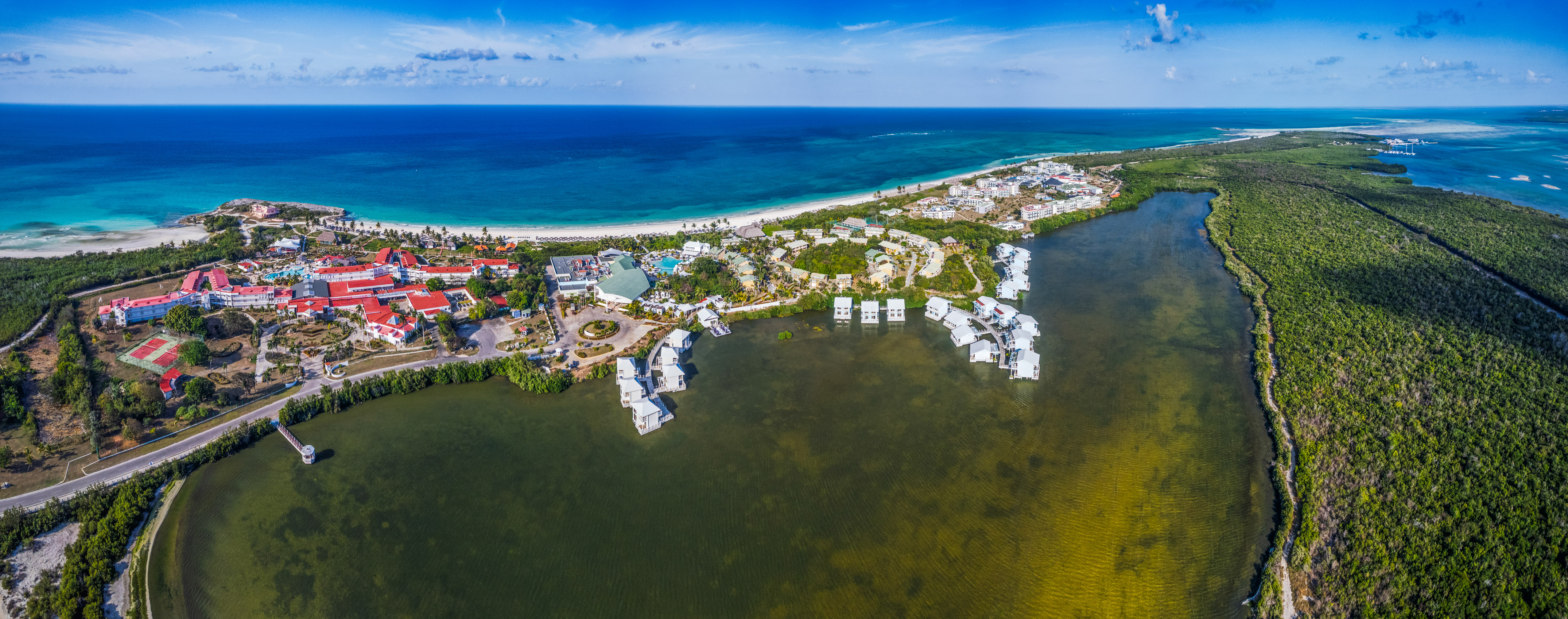 a body of water with buildings and a beach
