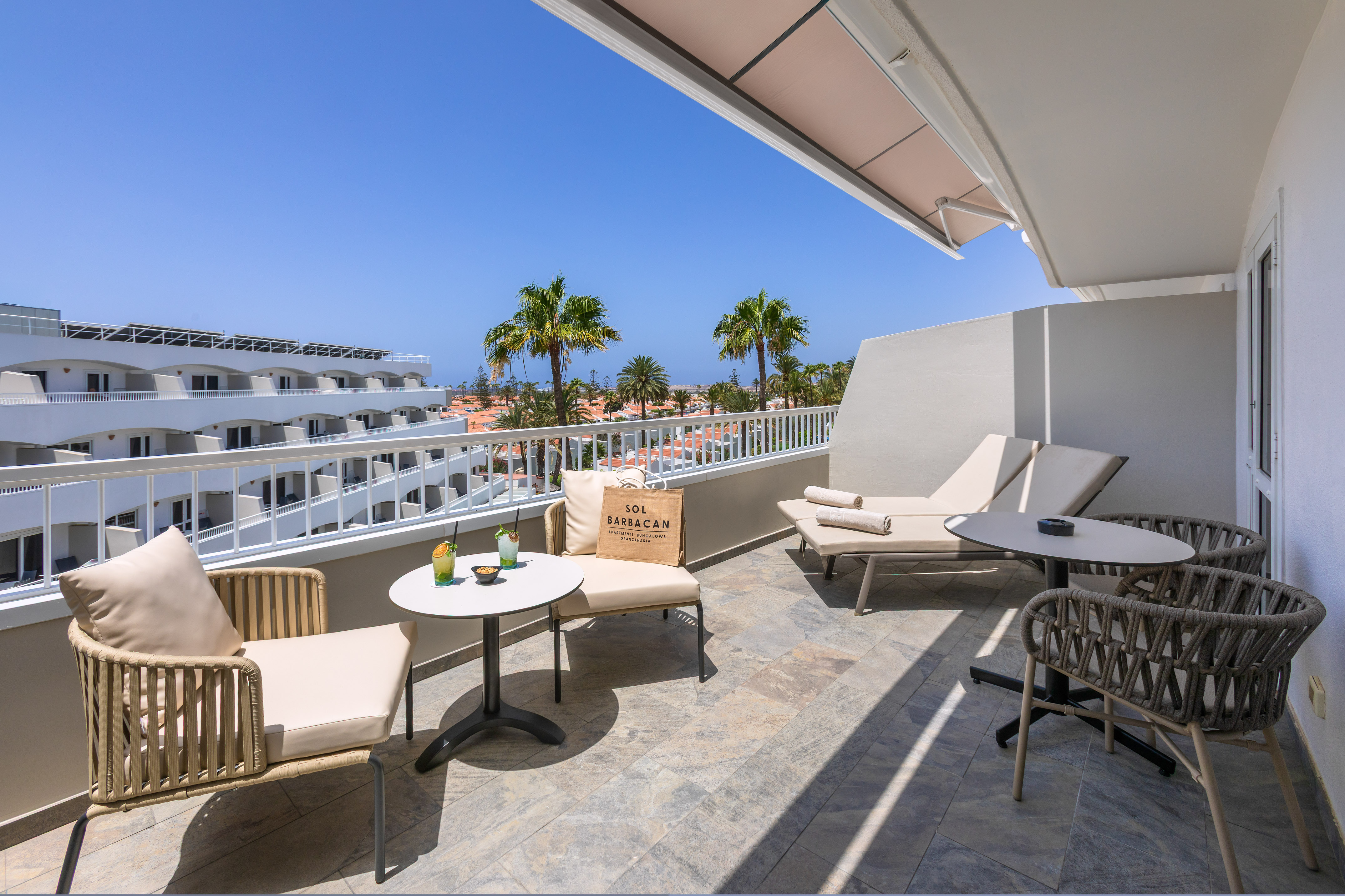 a patio with chairs and tables on a balcony