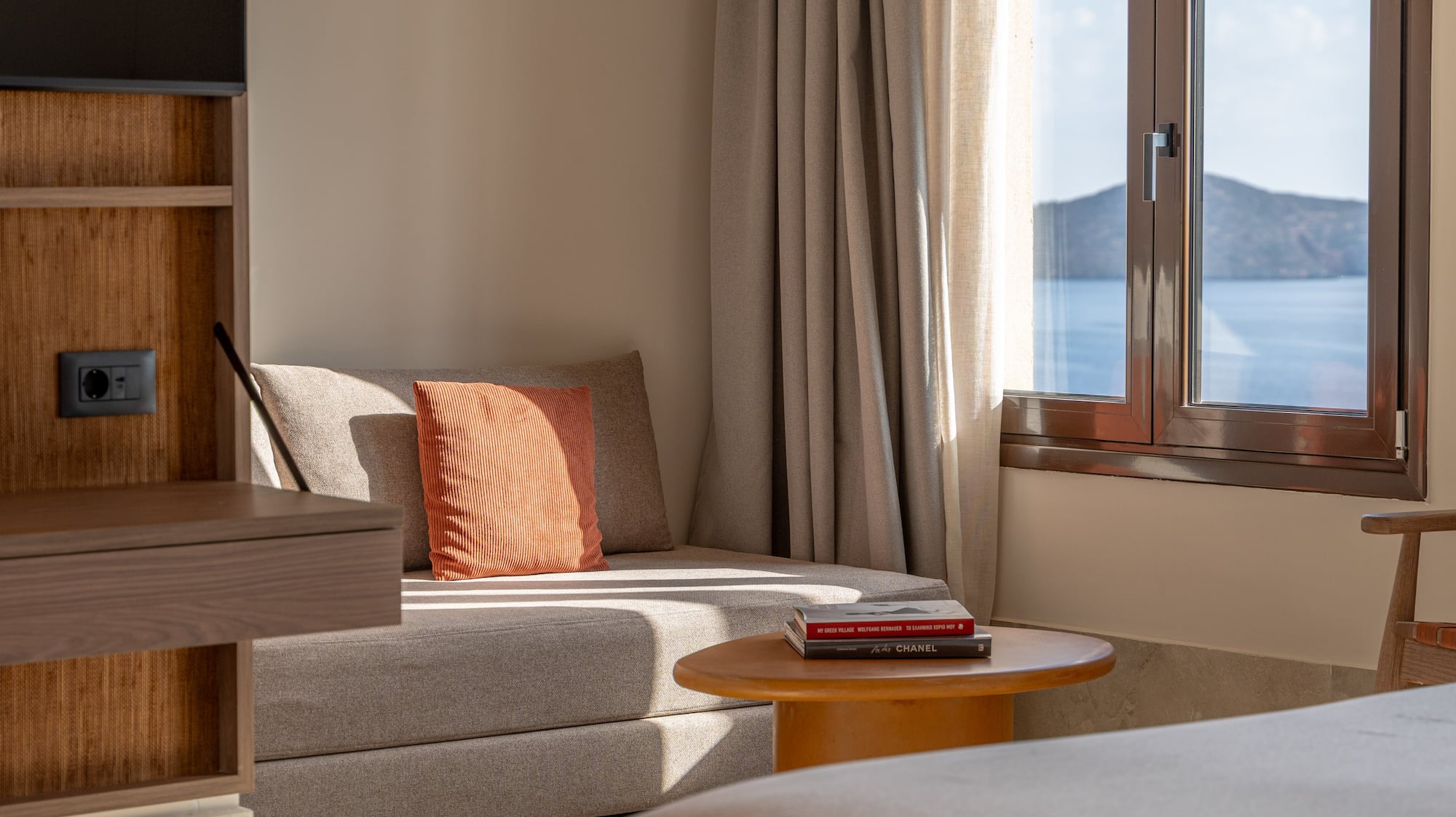 a room with a bed and a couch and a window