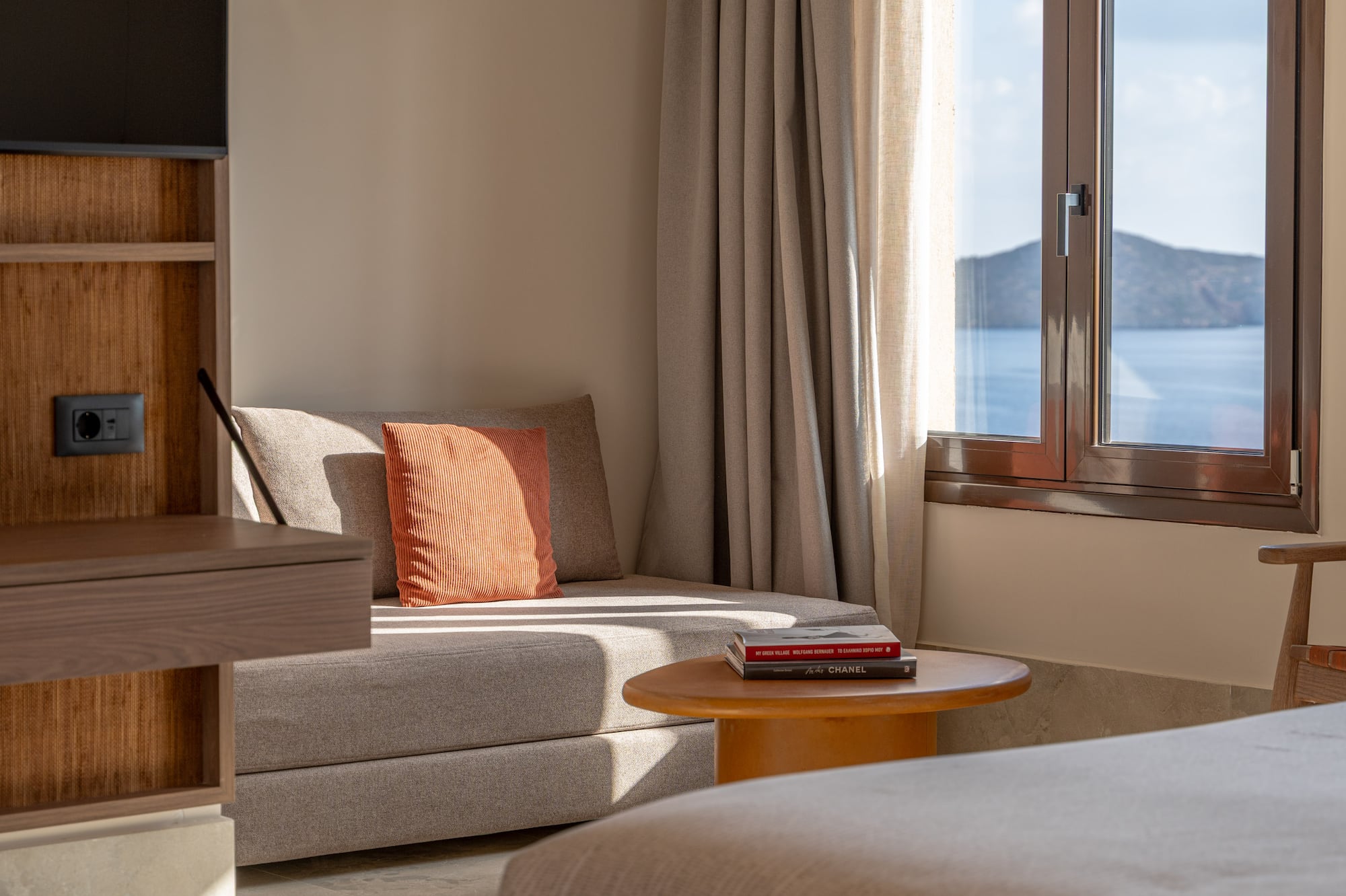 a room with a bed and a couch and a window