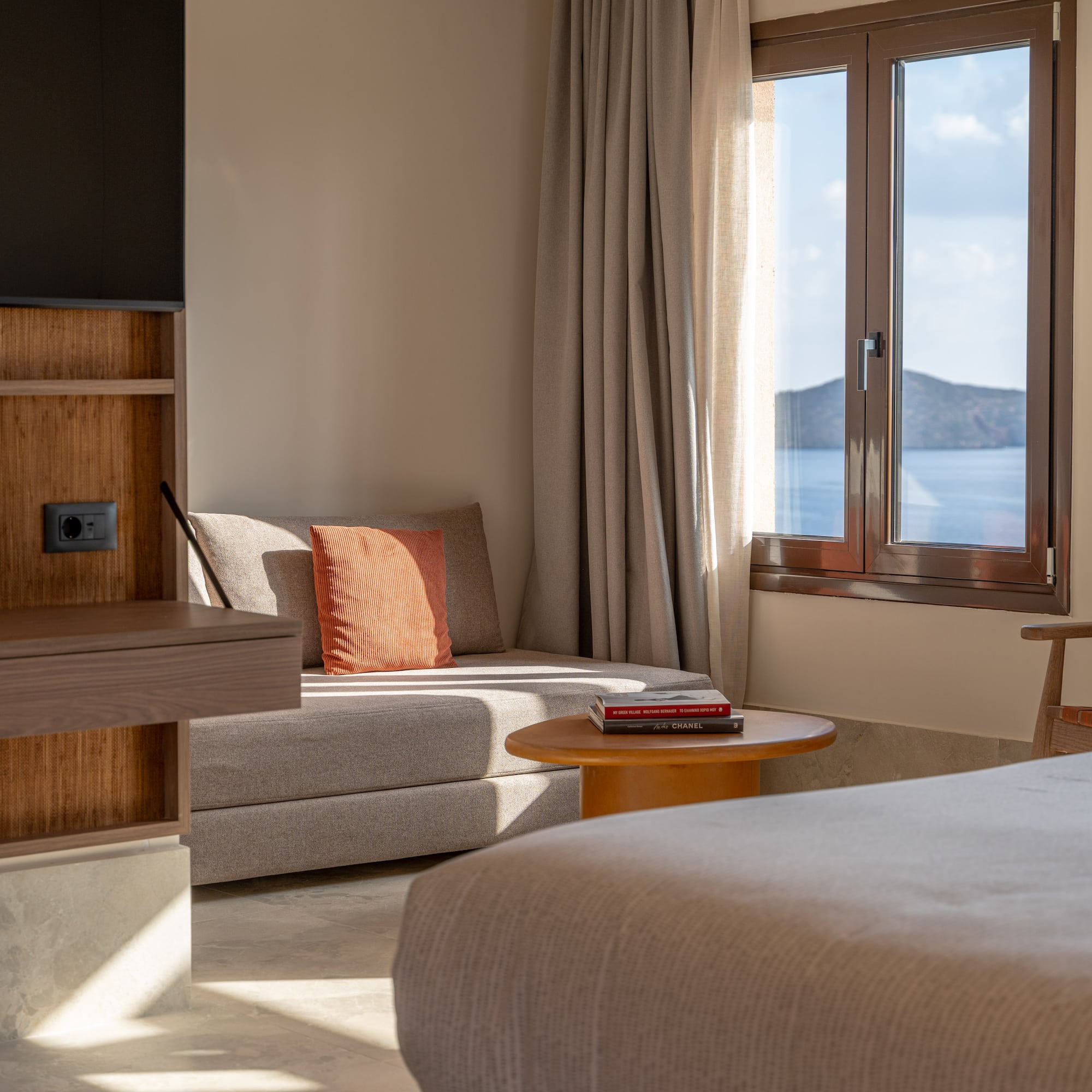 a room with a bed and a couch and a window