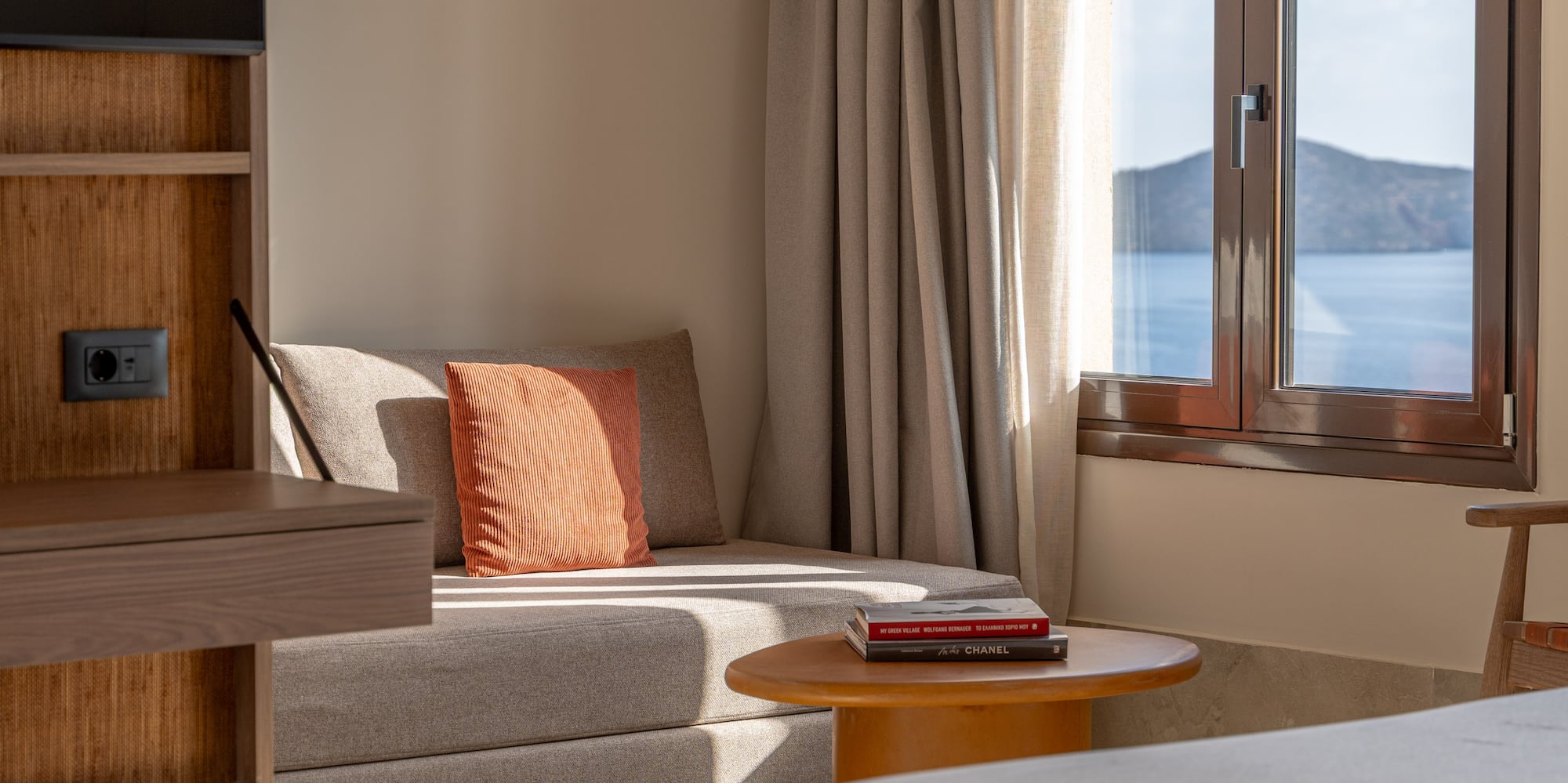 a room with a bed and a couch and a window