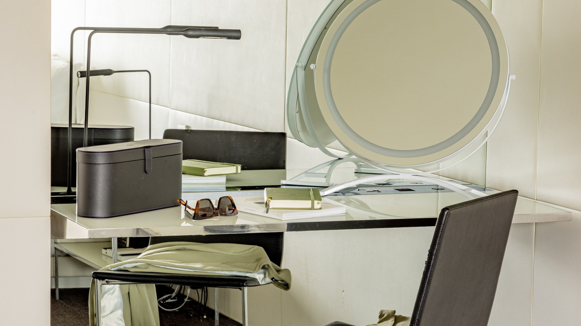 a chair and a desk with a mirror