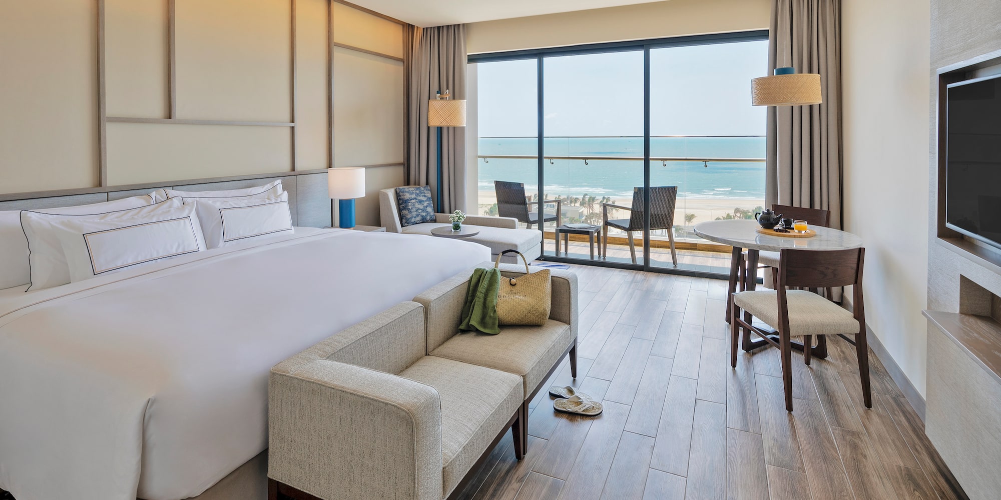 a room with a bed and a couch and chairs