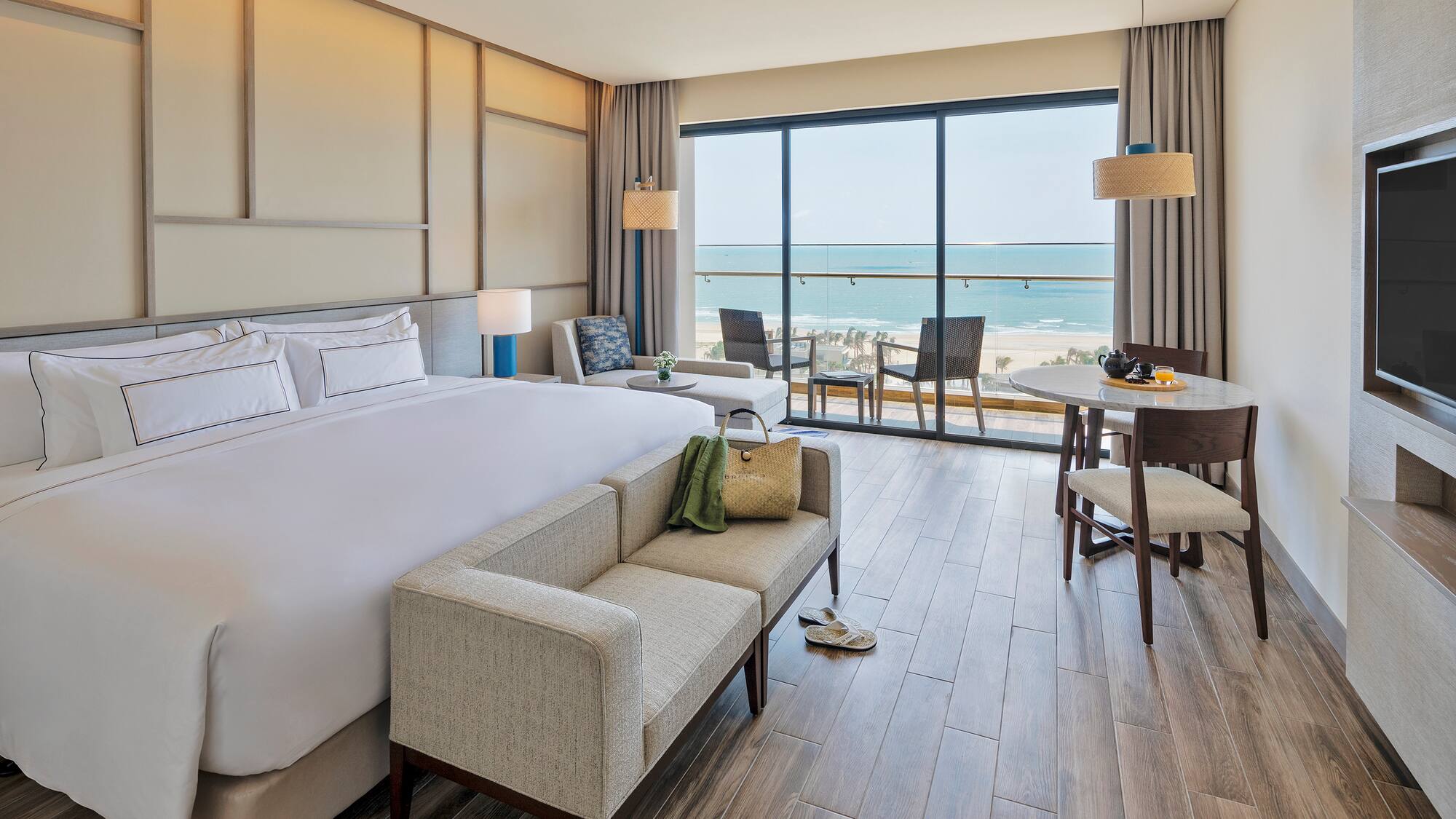 a room with a bed and a couch and chairs