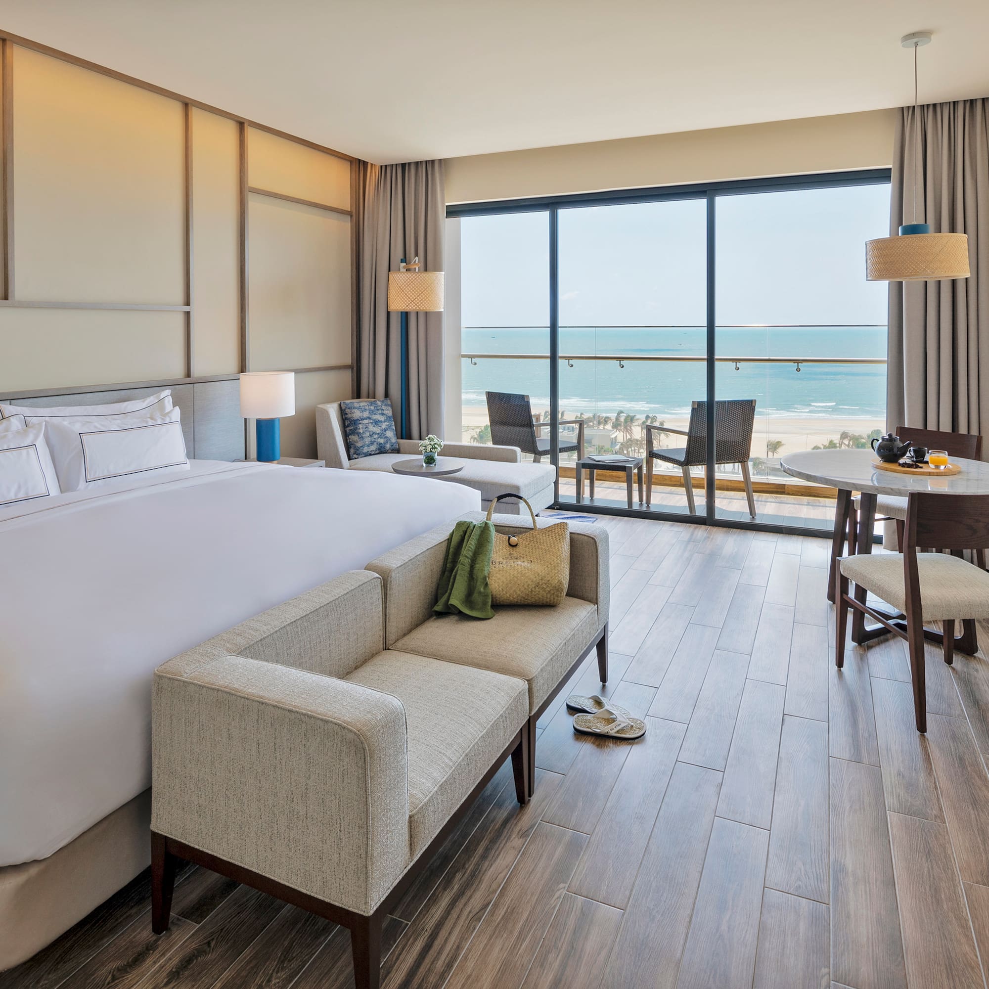 a room with a bed and a couch and chairs