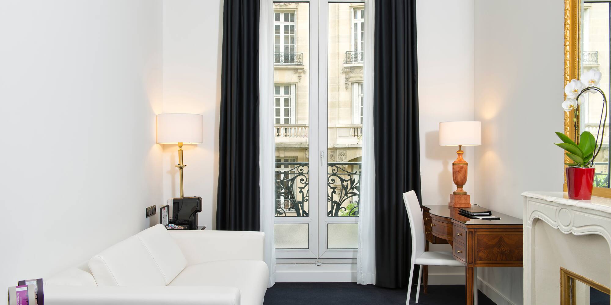 a room with a desk and a white couch