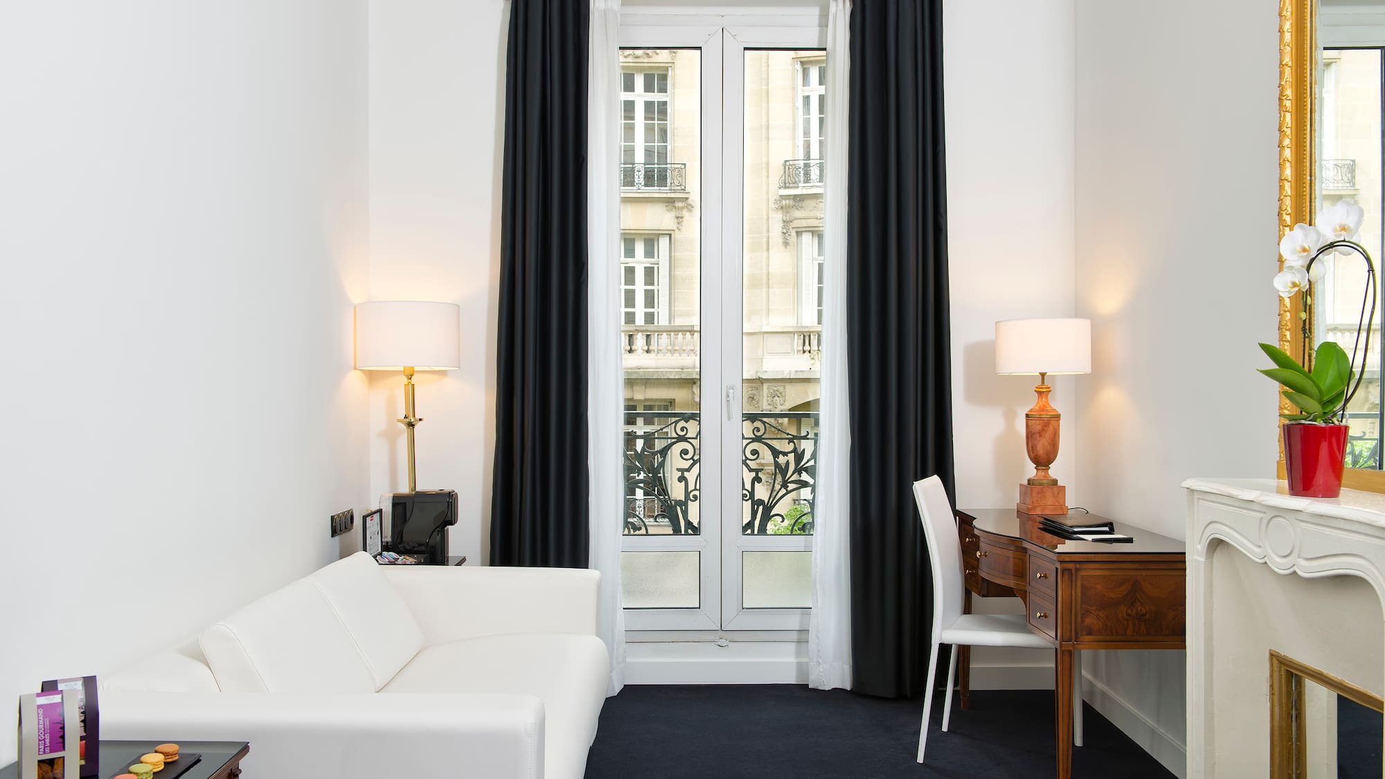 a room with a desk and a white couch