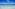 a beach with clear water and blue sky