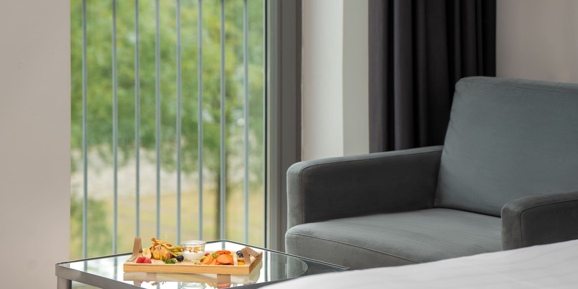 a tray of food on a table in a room with a couch and a balcony