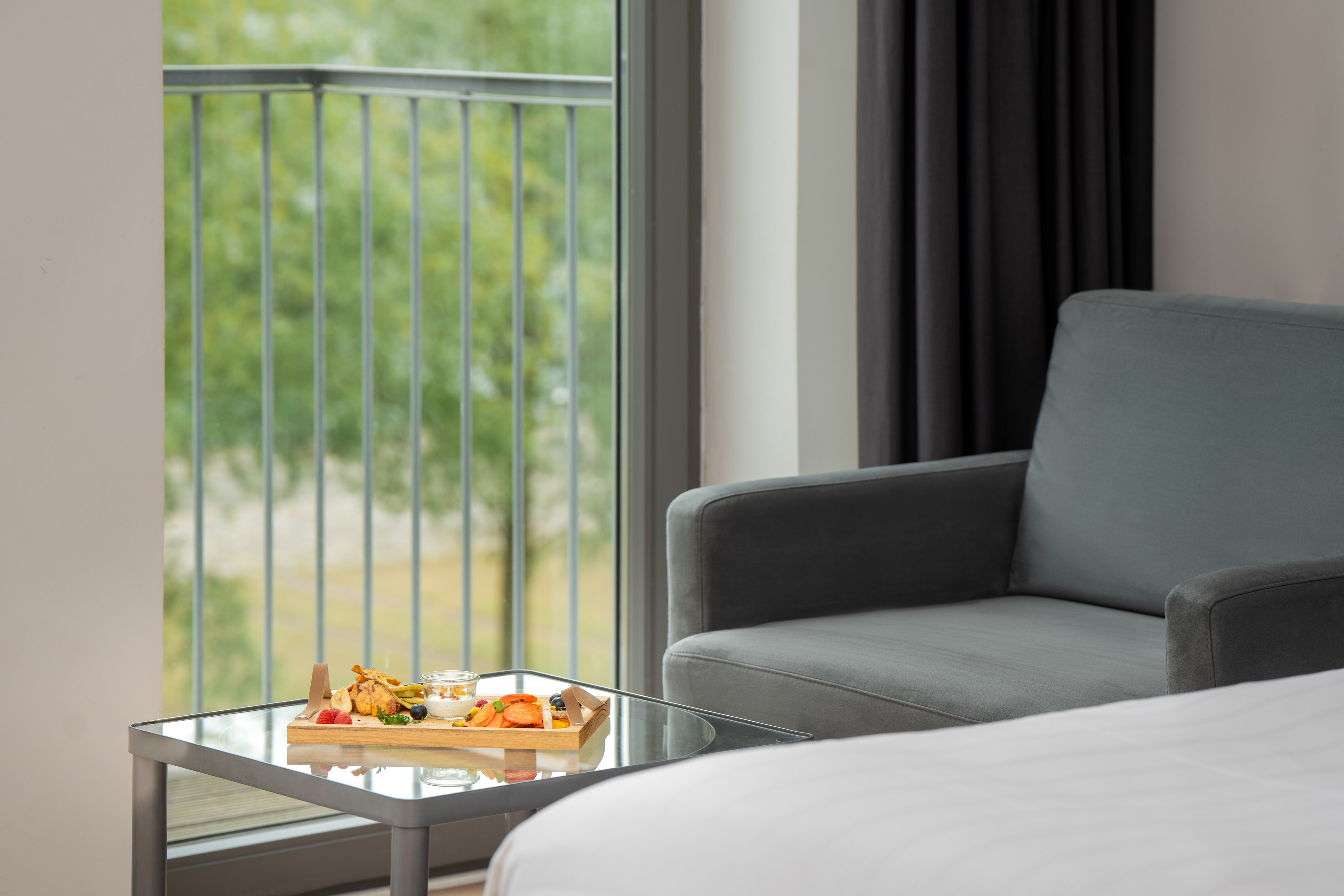 a tray of food on a table in a room with a couch and a balcony