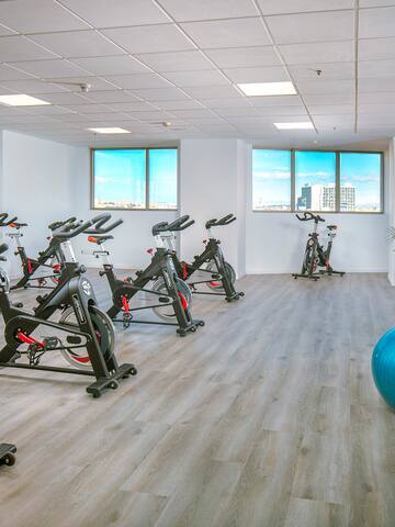 a room with exercise bikes and a ball