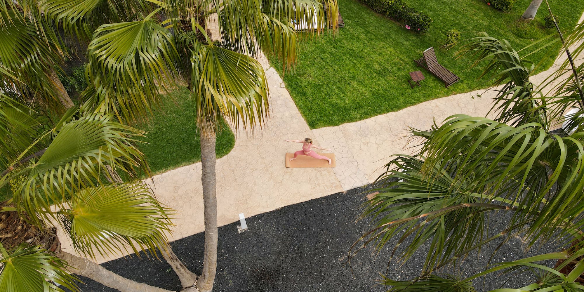 a person doing yoga on a mat in a yard