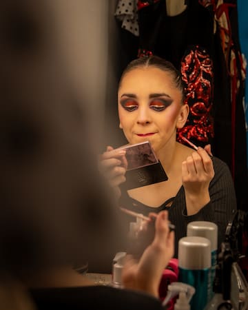 a woman putting on makeup