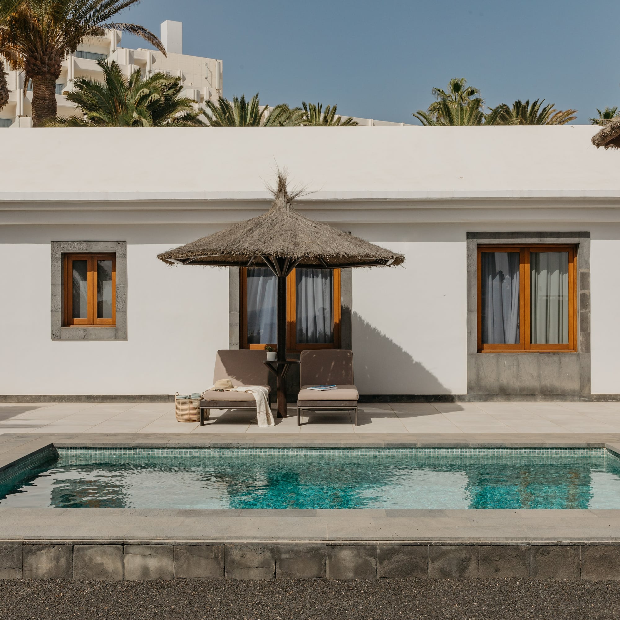 a pool in front of a white building
