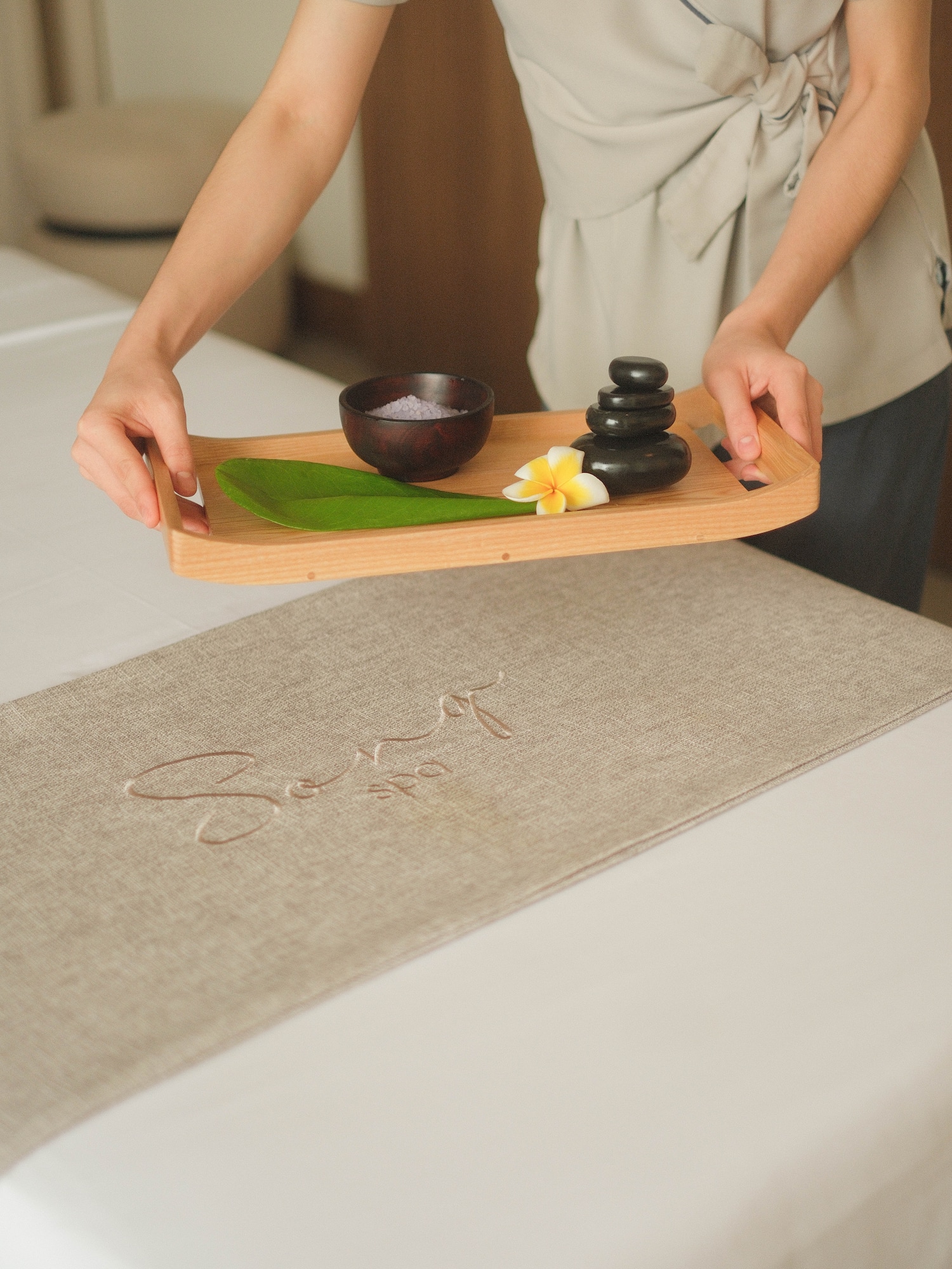 a person holding a tray with a bowl and a bowl on it