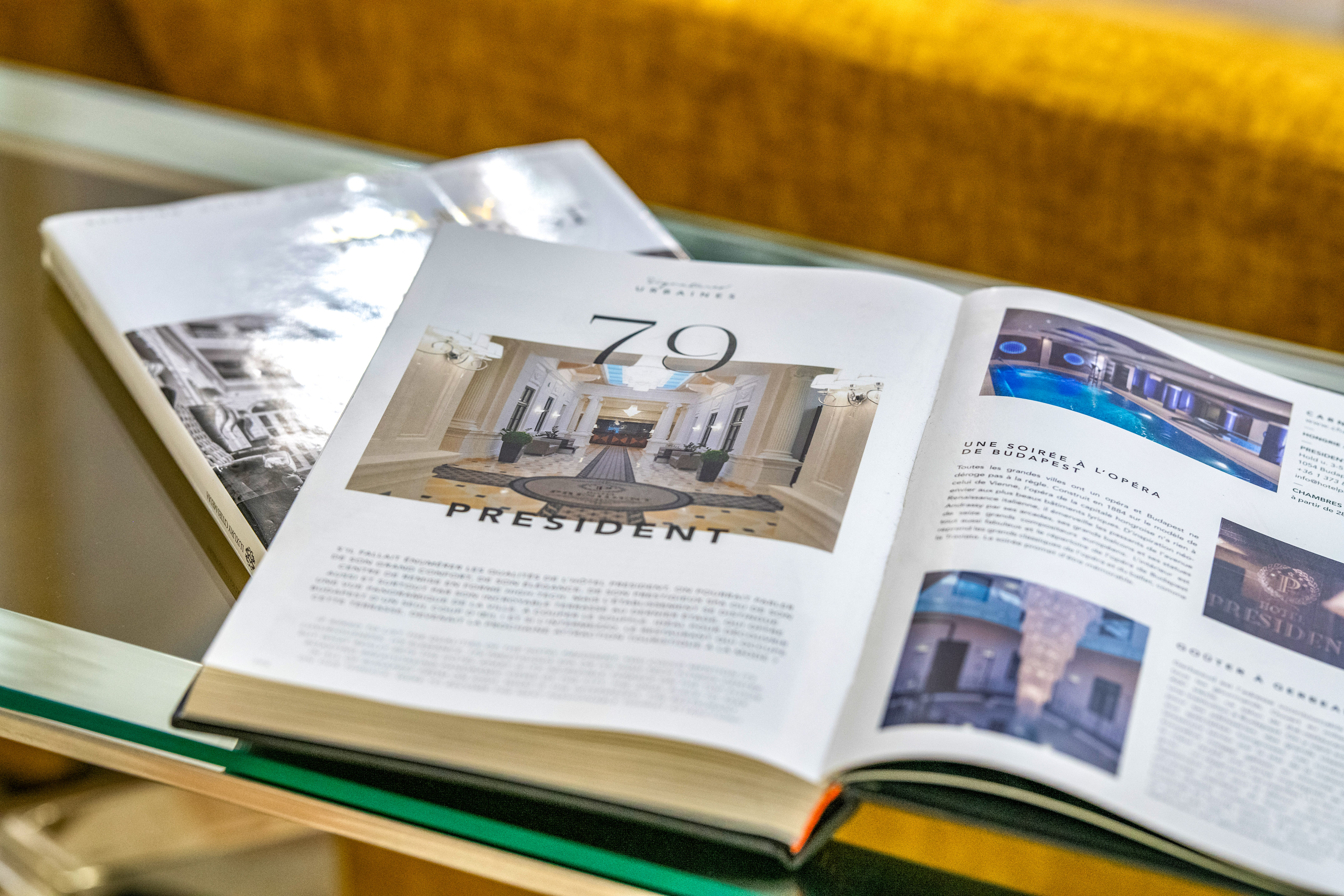 Open luxury hotel magazine featuring Hotel President lobby and indoor pool. - Vienna Boardroom - Hotel President Budapest Affiliated by Meliá, Budapest