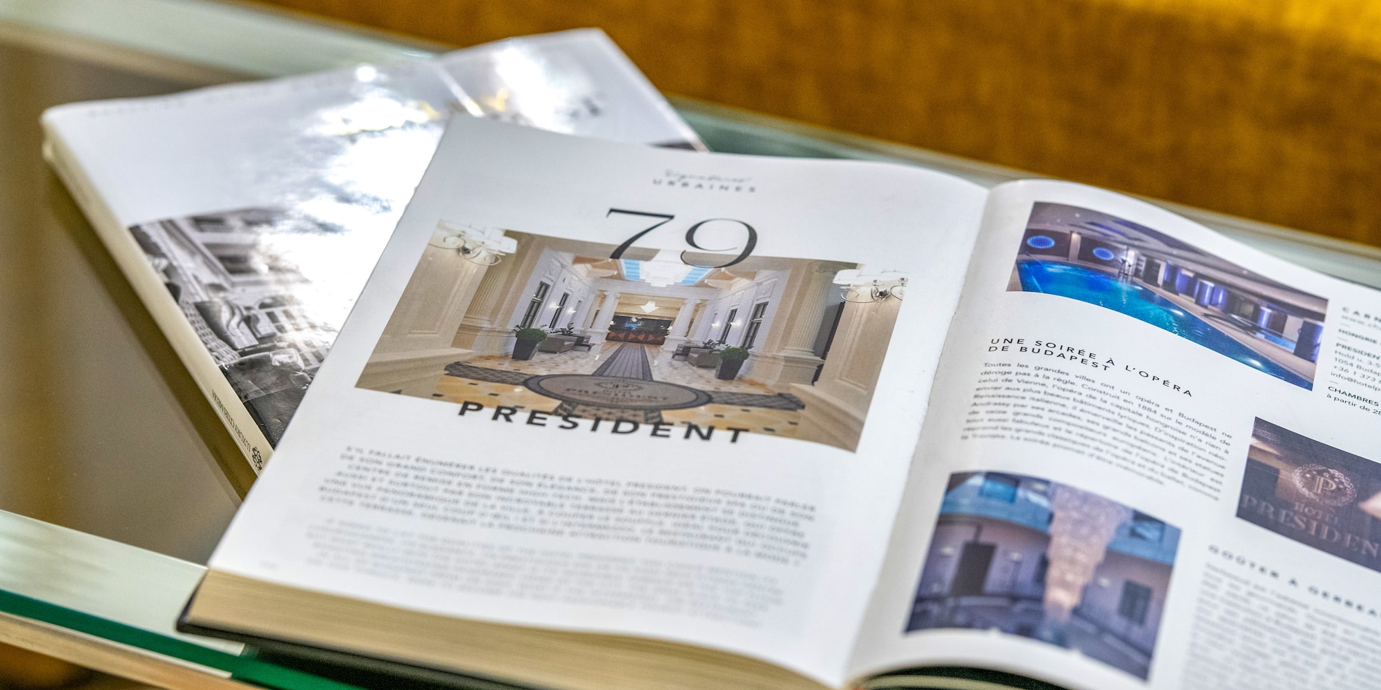 Open luxury hotel magazine featuring Hotel President lobby and indoor pool. - Vienna Boardroom - Hotel President Budapest Affiliated by Meliá, Budapest