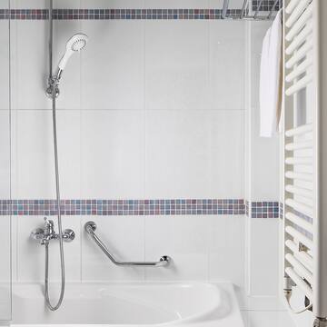 a bathtub and shower in a bathroom