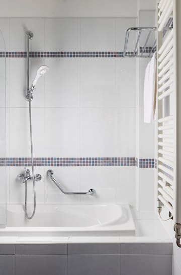 a bathtub and shower in a bathroom