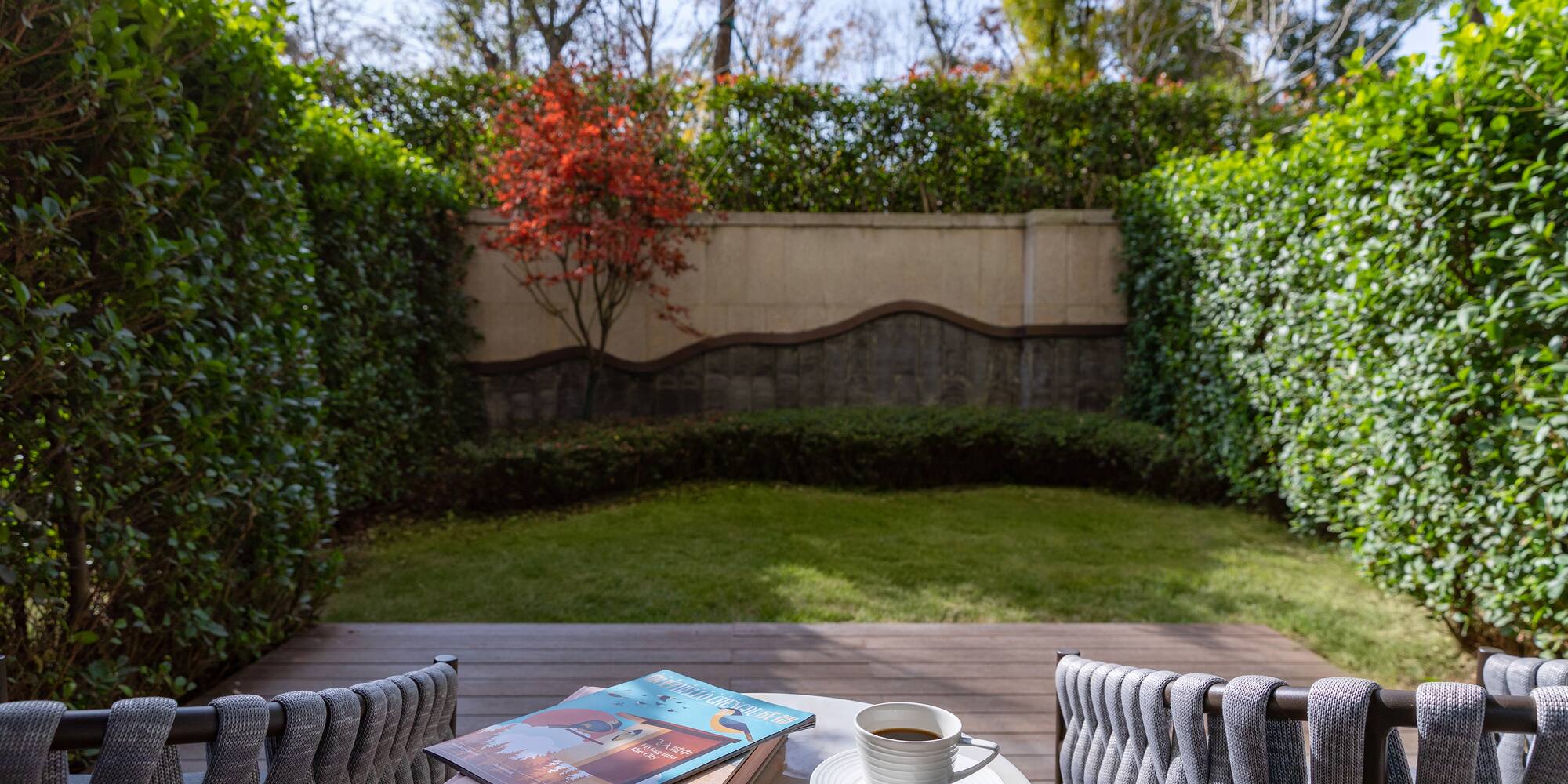 a table with a cup of coffee and books on it