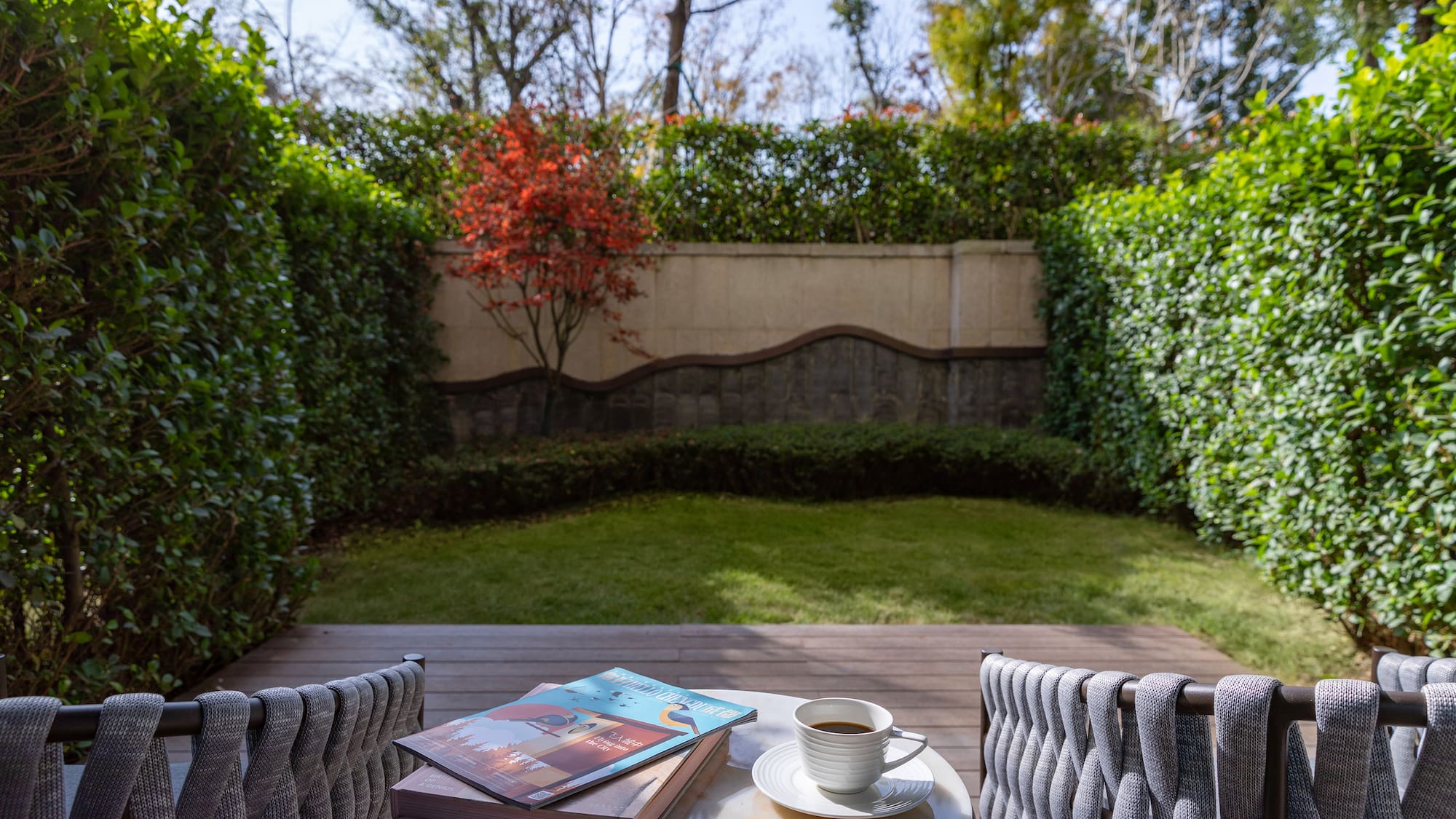 a table with a cup of coffee and books on it