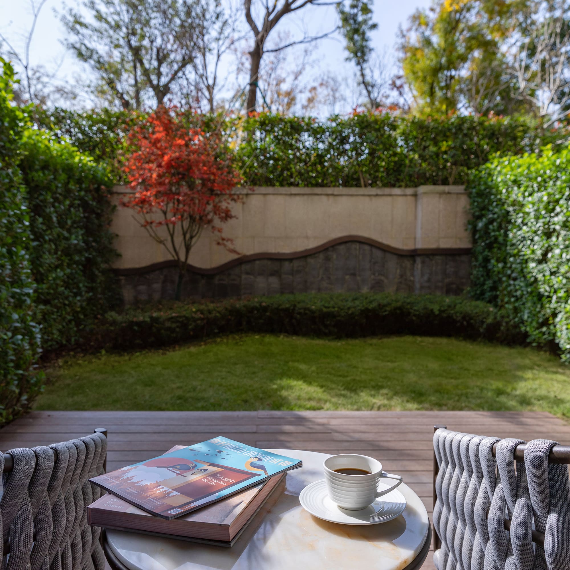 a table with a cup of coffee and books on it