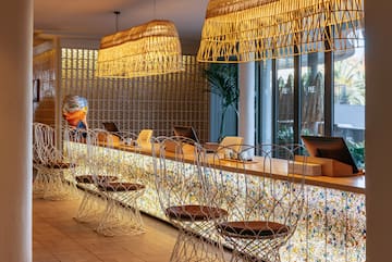 a room with a bar and chairs