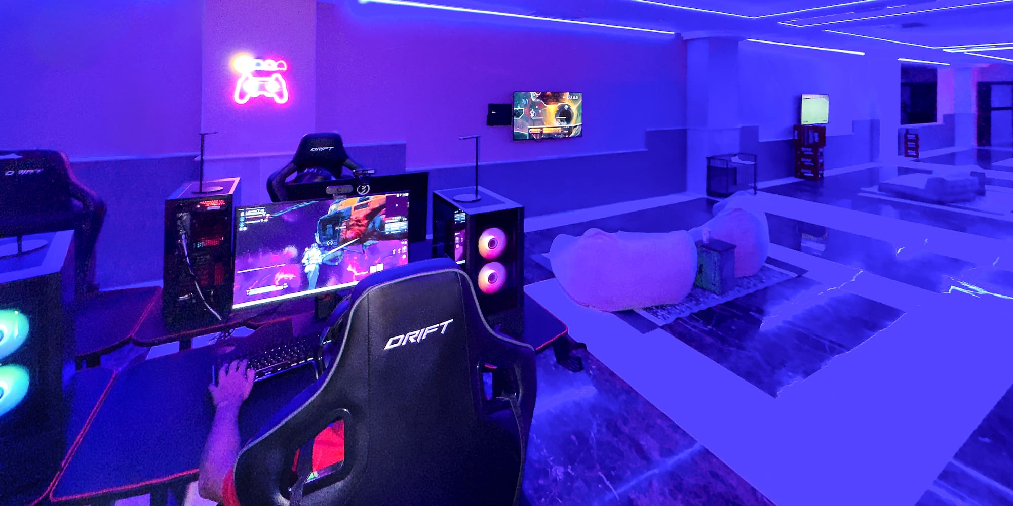 a room with a gaming room and a computer