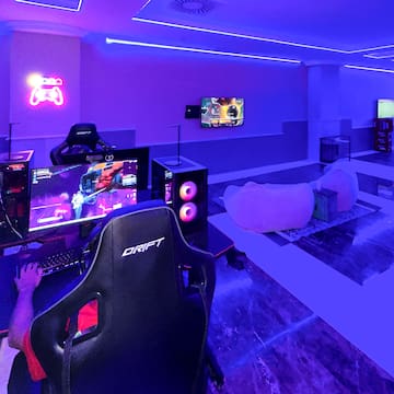 a room with a gaming room and a computer