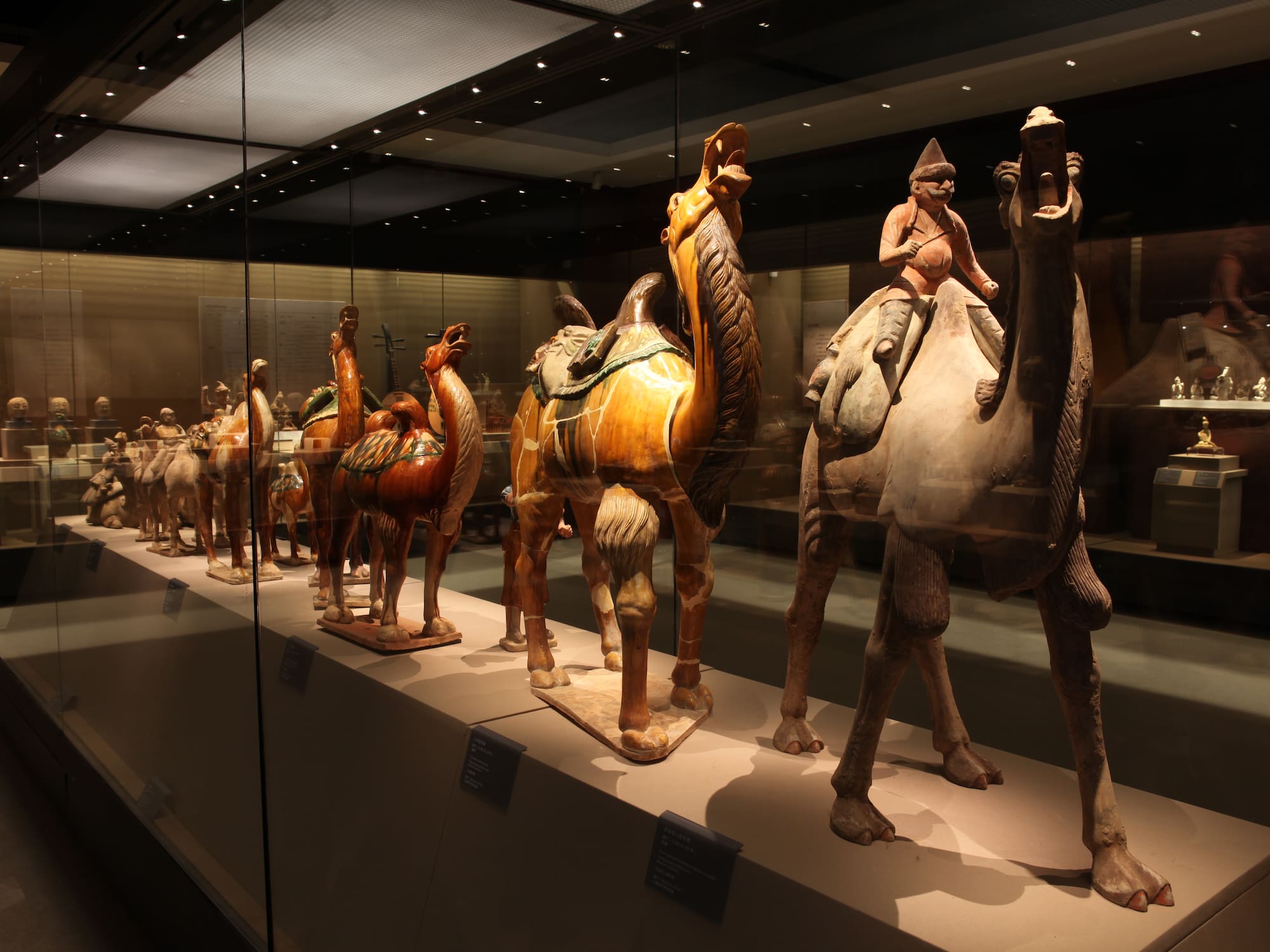 a group of statues of camels and a woman riding a camel
