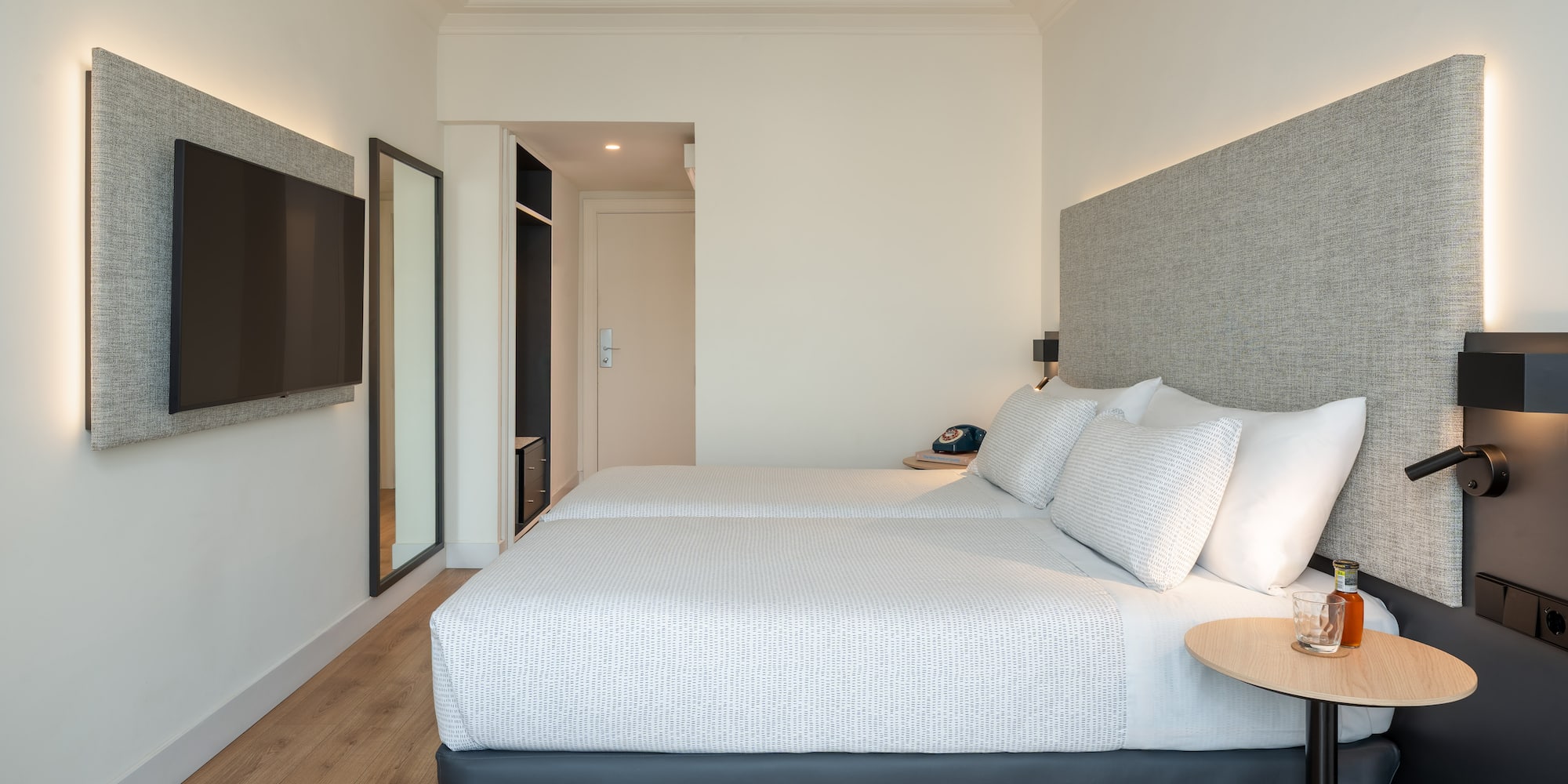 a room with two beds and a tv