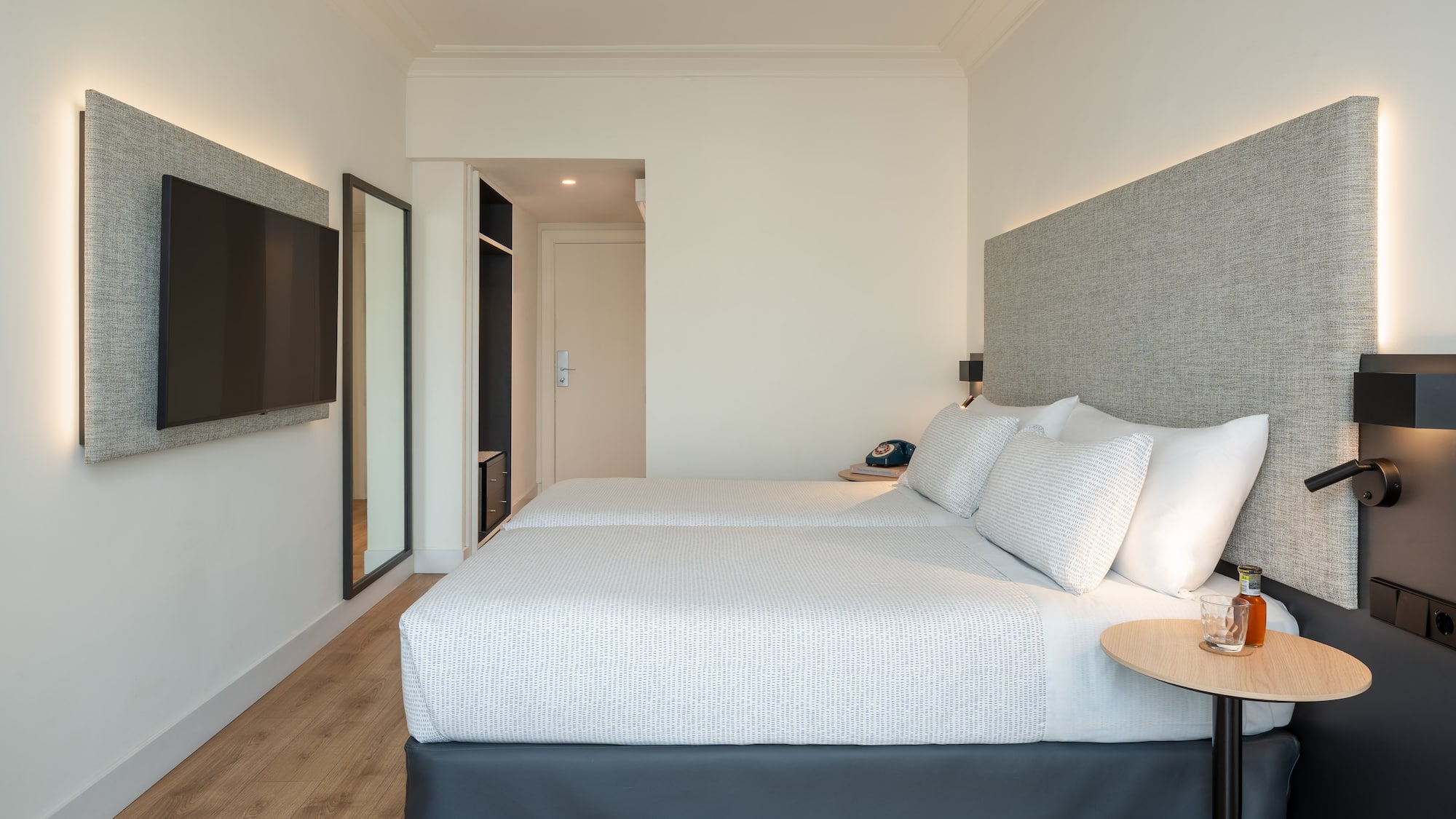 a room with two beds and a tv