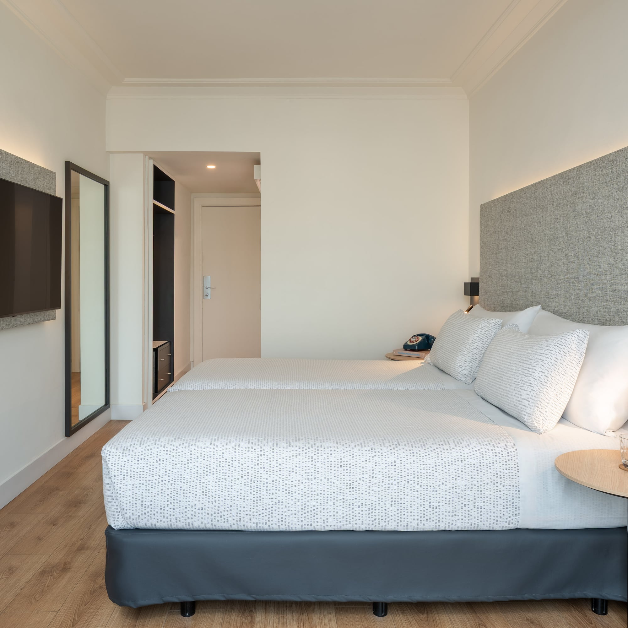 a room with two beds and a tv