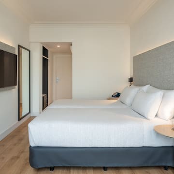 a room with two beds and a tv